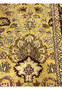 Detailed pattern section of 9x12 gold Agra rug featuring symmetrical floral elements and scrolling vines on warm mustard background.