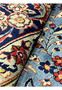 Authentic Persian Kashan rug wool pile texture closeup showing natural abrash blue field