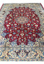 Midfield view 10x13 Persian Isfahan wool rug crimson red field ivory floral arabesques blue scrollwork animal border