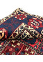 Folded corner of 7x10 hand-knotted Bakhtiari Persian rug revealing weave structure and pile height