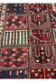 Close-up of hand-knotted khane compartments in 6'8x10 Persian Bakhtiari red and navy rug