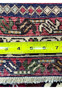 Backside of 5x8 Persian Afshar rug with ruler showing thick pile depth and knot density