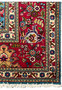Border edge closeup of 10x13 Persian Tabriz rug, crimson red vine border with ivory guard stripes