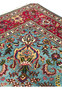 Upper edge of 10x13 Persian Tabriz rug, crimson border meeting sky blue field with vase motif