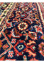 Navy border closeup with palmettes and fish motifs, Persian Bijar rug floral design