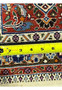 Back of authentic Persian Moud rug measured with ruler, showing dense hand-knotted density