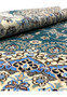 Rolled edge view showing dense pile and fine silk highlights across the emerald green and ivory surface