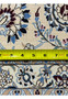 Closeup of the rug backside showing individual hand-tied knots and 600 KPSI fine weave