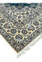 Full-length side profile of this authentic 8x12 Nain rug with ivory fringe and layered floral borders