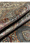 Rolled edge of this Turkish silk rug showing super thin 0.2 inch pile and silvery ivory ground