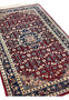 Angled view of a Persian Tabriz rug emphasizing depth, pile texture, central medallion definition, and harmonious ruby, navy, and ivory palette