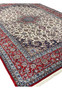 Angled view 8x12 premium Persian Isfahan wool silk rug ivory field crimson red border navy medallion handmade Persia