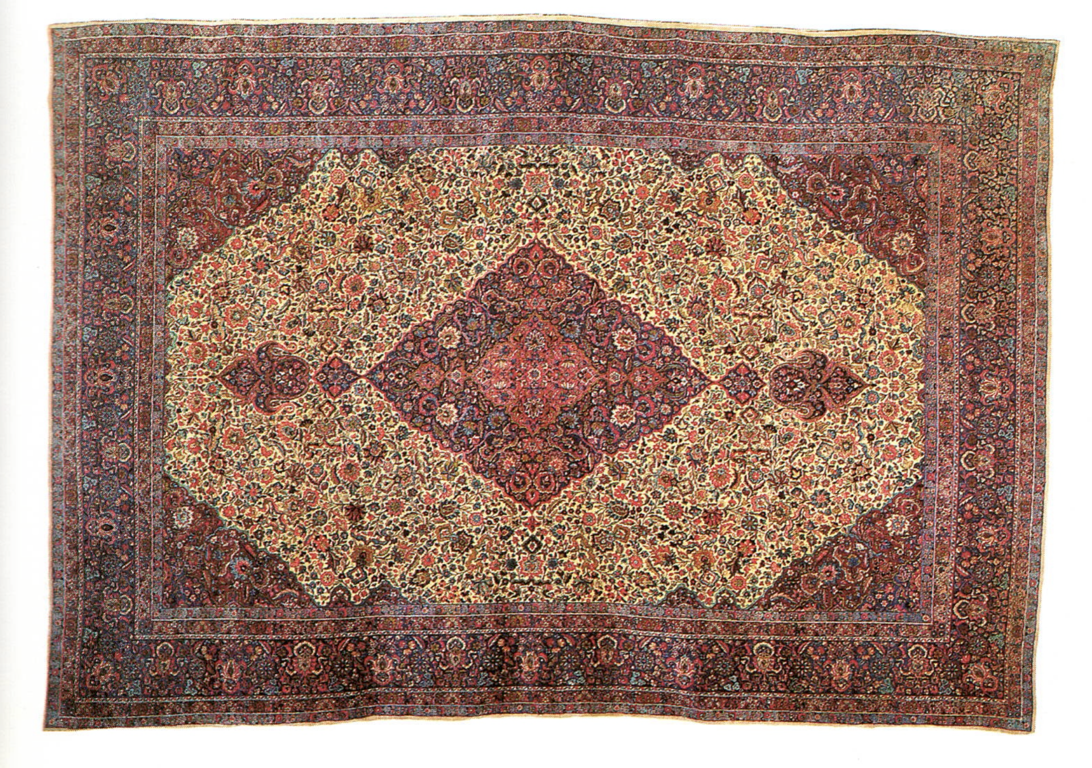 A 19th century Persian Kerman rug with a central medallion on a finely flowered ivory field