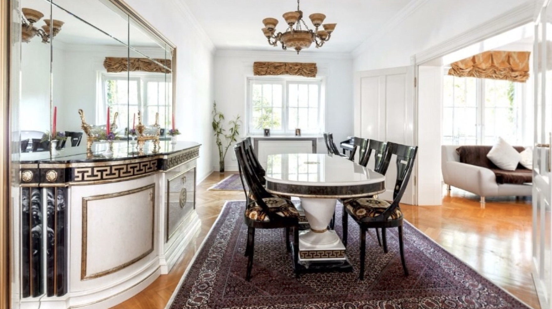 Customer dining room with a durable Persian Bijar iron rug under a wooden dining table, chairs resting fully on the weave