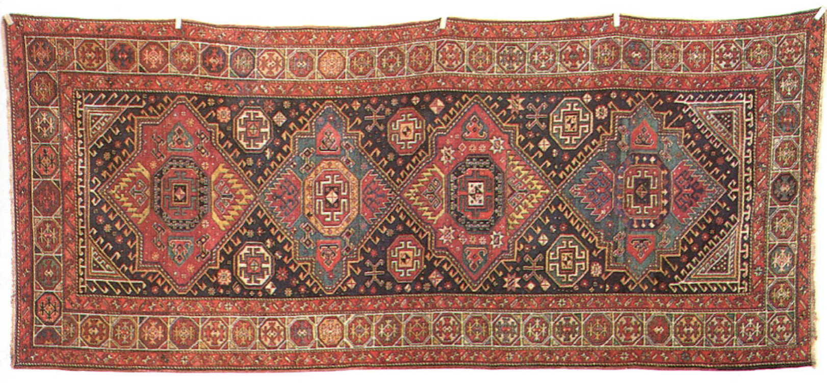 Caucasian Medallion Kazak rug with bold geometric medallions in red blue and ivory from the late 19th century
