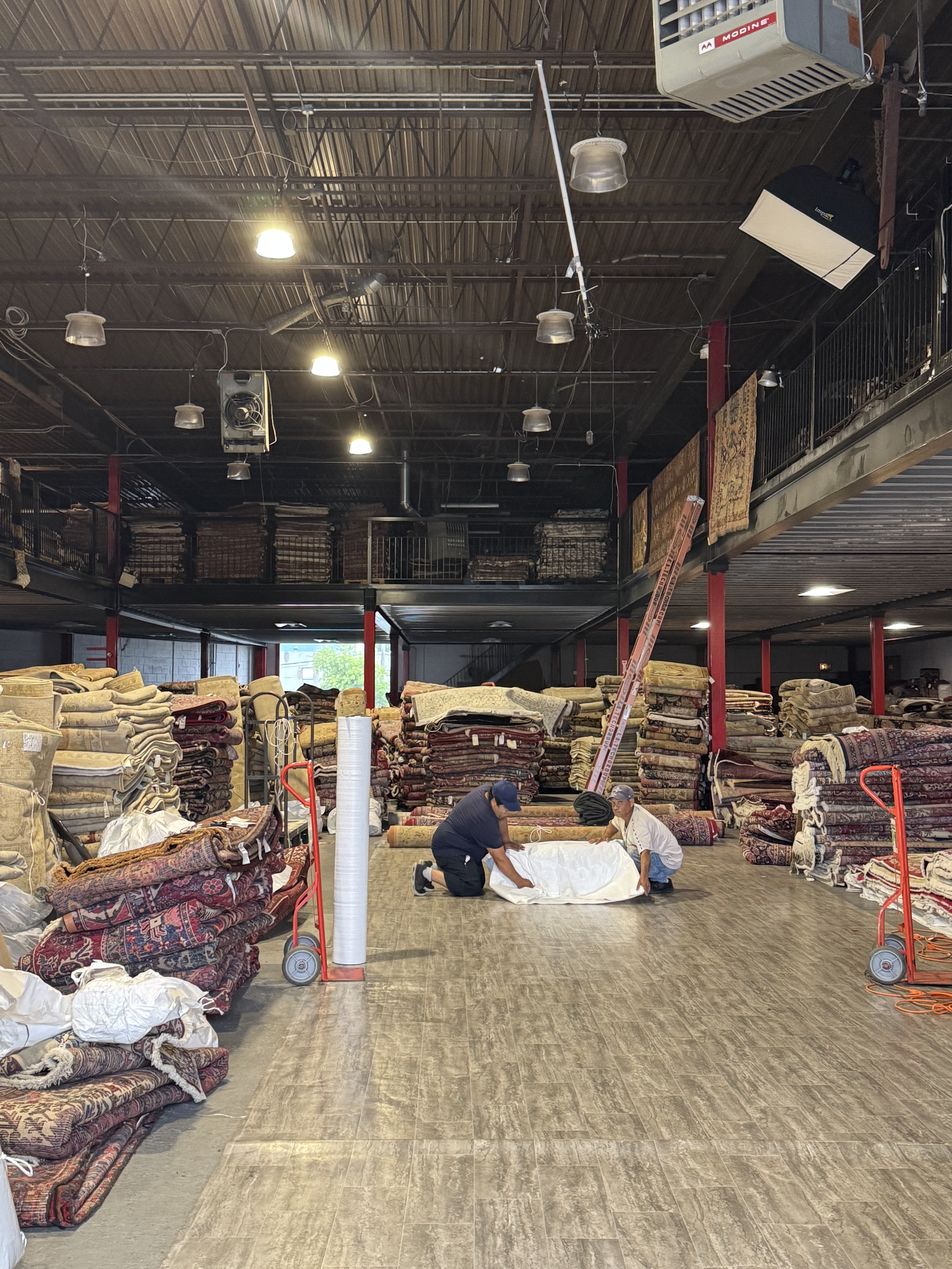 A hand-knotted rug being prepared to ship inside the Rugs.net warehouse in Freeport, New York