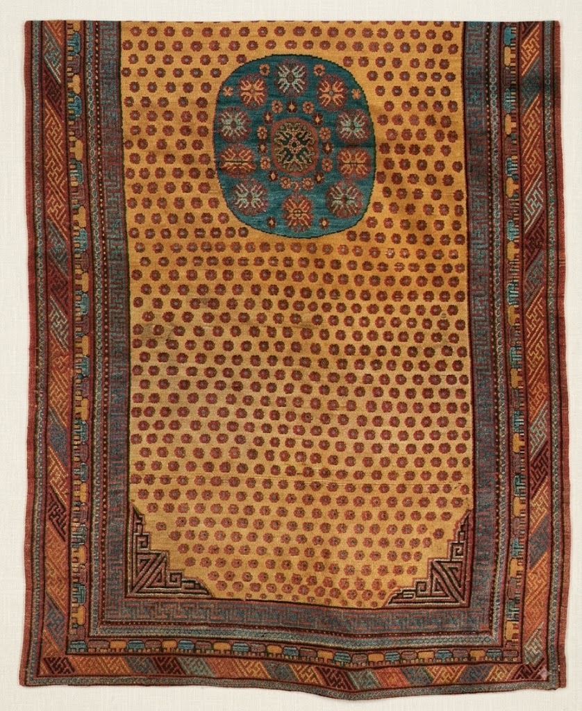 Detail of an early 20th century Gansu medallion rug imitating East Turkestan design with roundish blue medallion