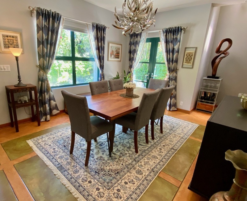 Customer dining room with a fine ivory and blue Persian Nain rug sized generously under the dining table