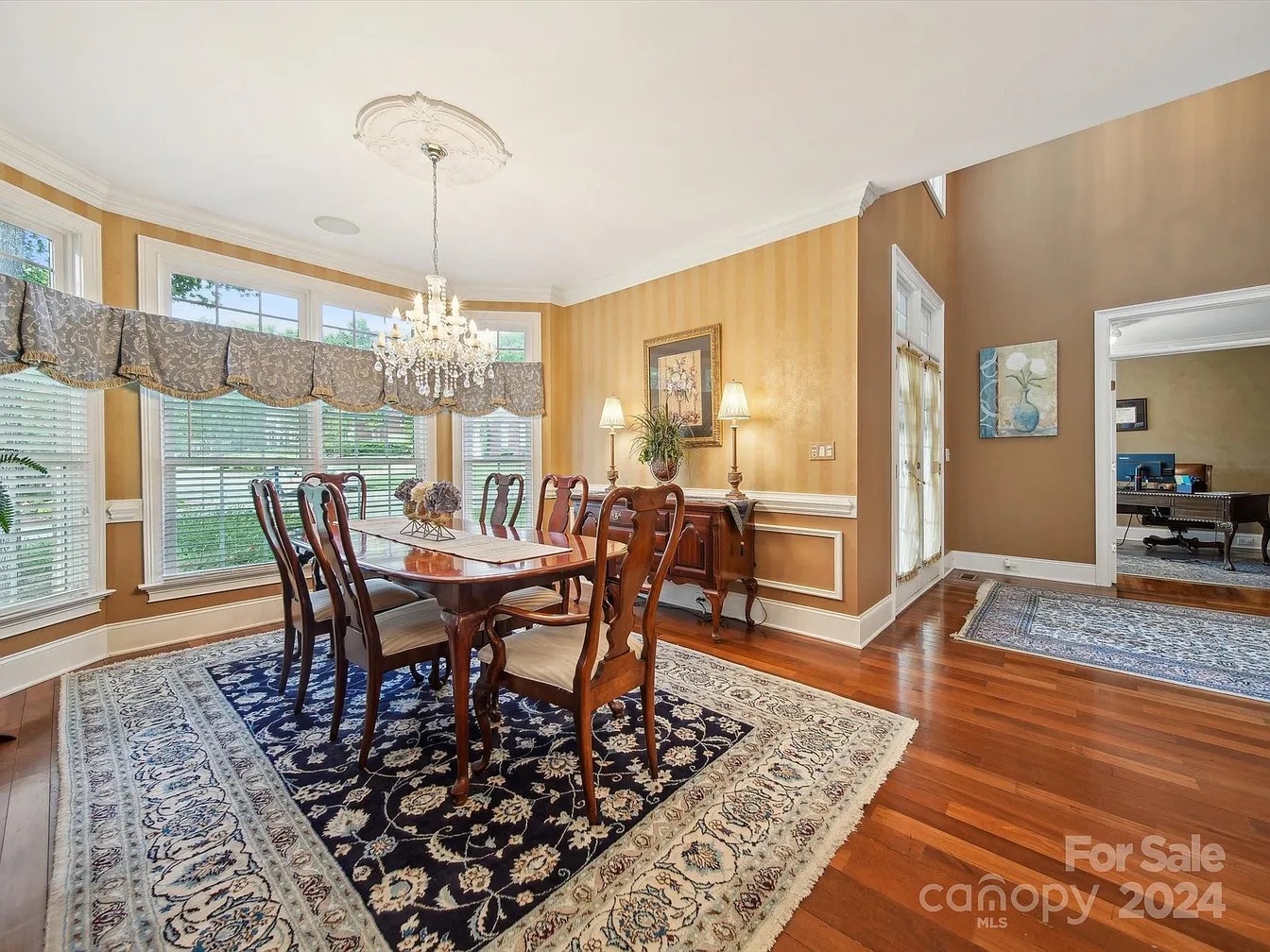 Customer dining room with a navy blue Persian Nain rug under a dark wood dining table, rich deep blue field