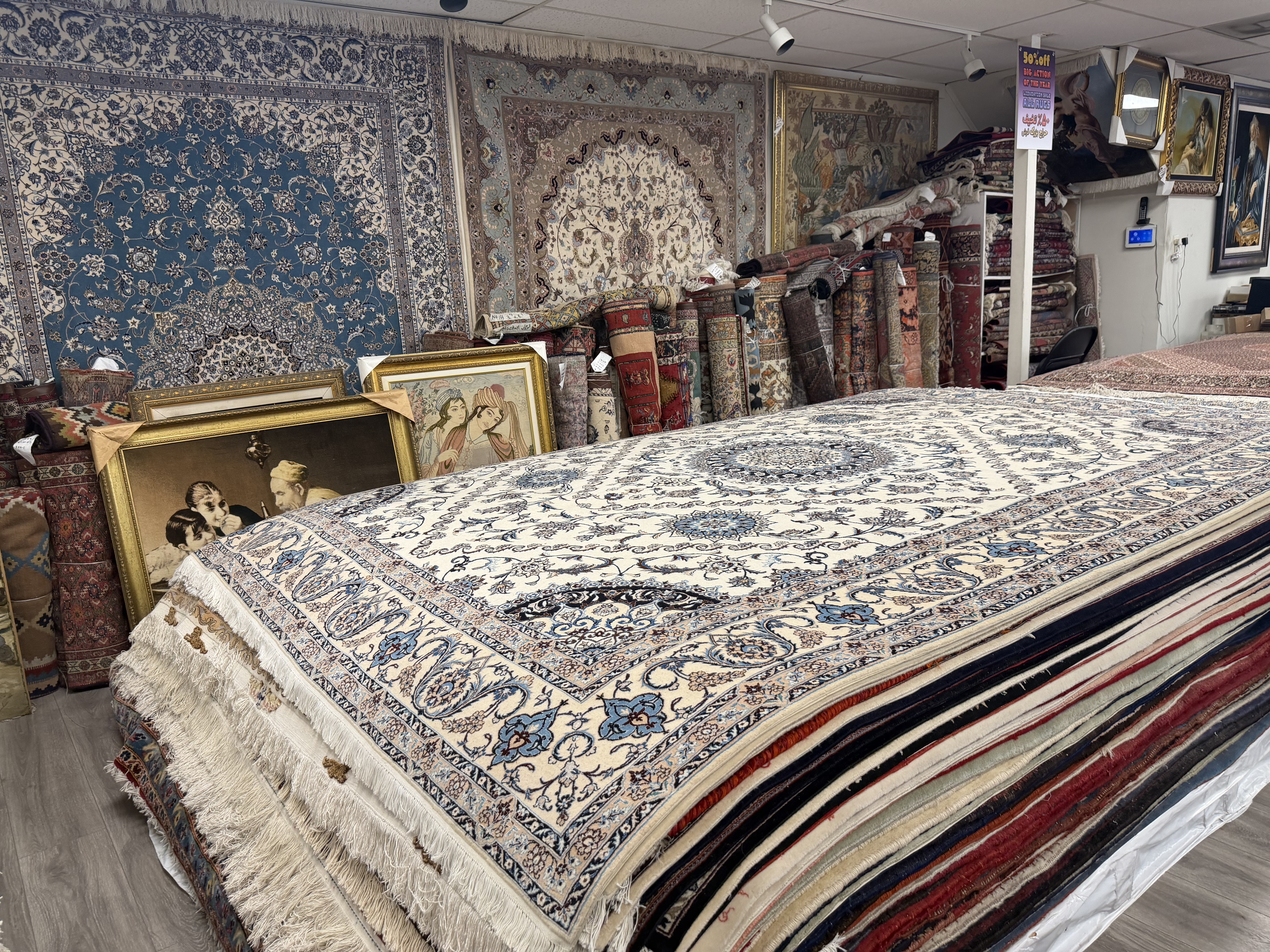 Persian rugs stacked and hung inside the Rugs.net Los Angeles gallery in Westwood