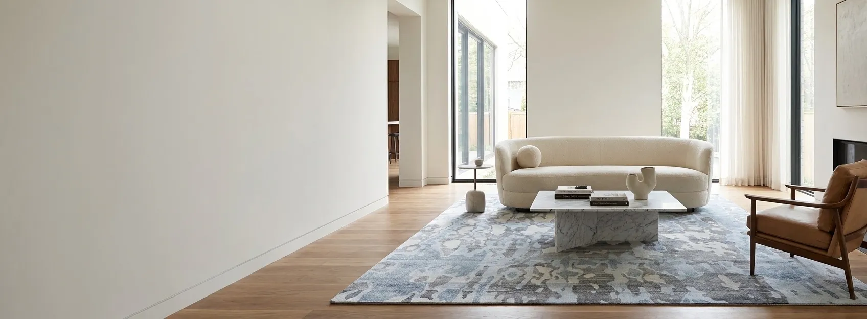 A contemporary rug in a bright, design-forward living room