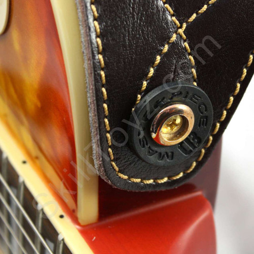 Black Guitar Strap Lock shown in use on an electric guitar. Helps secure your strap to your guitar.