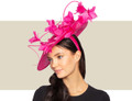 Women's fuchsia statement fascinator hat with sculptural quill vine and feather flowers