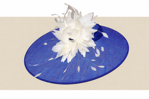 Elegant royal blue statement hat with dramatic white feather spray