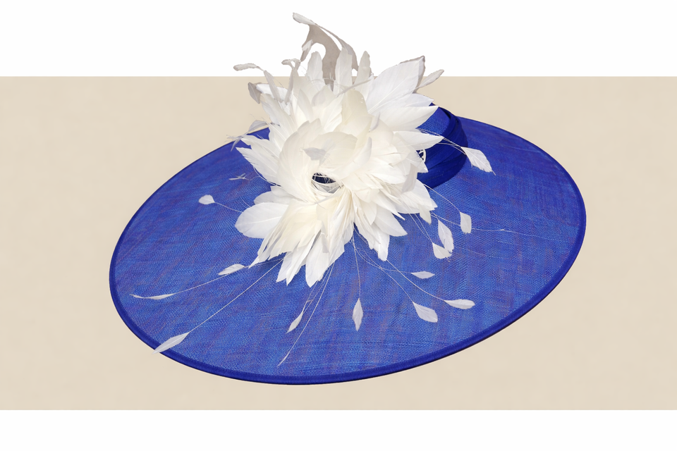 Elegant royal blue statement hat with dramatic white feather spray
