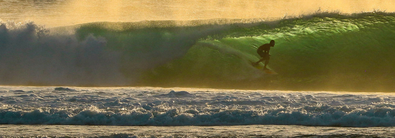 Shop Tour Series surf wax - competitive surfer getting barreled on a wave.