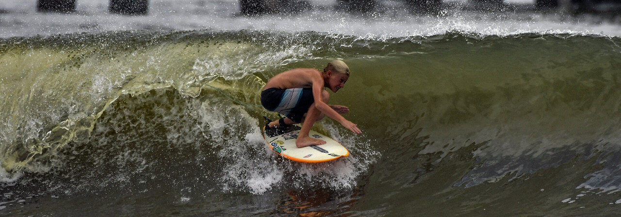 Shop Tour Series competition wax. Photo of a surfer riding a wave barrel Shop Tour Series competition wax. Photo of a surfer riding a wave barrel