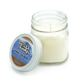 Pina colada scented 7 ounce candle in glass jar with twist off lid.