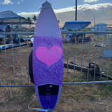 Surfboard with a purple and pink heart design made with Sticky Bumps' Bright Bars colored surf wax. Surfboard with a purple and pink heart design made with Sticky Bumps' Bright Bars colored surf wax.