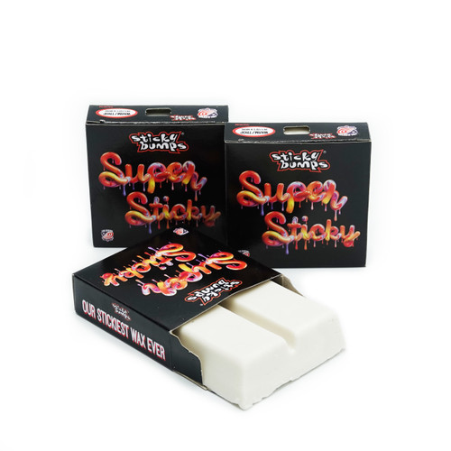 Three black boxes, two closed and one open holding our Super Sticky warm/tropical surf wax. 