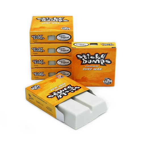 Six iconic yellow and orange boxes of Sticky Bumps Original formula surf wax.