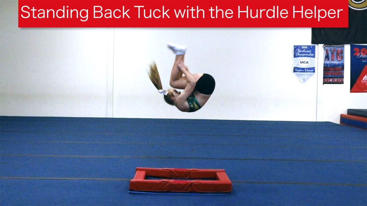 Play Video - Standing Back Tuck with Hurdle Helper