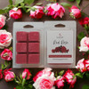 Red Rose wax melt clamshell and cubes surrounded by red and pink roses in a floral circle