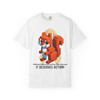 White unisex tee with pixelated squirrel design holding a coffee cup, golden ribbon background, and bold text reading “It Deserves Action” – Childhood Cancer Awareness Tee by Coo Coo’s Coffee.