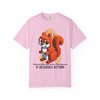 Soft blossom pink tee with pixel squirrel coffee graphic, golden ribbon background, and “It Deserves Action” text – Childhood Cancer Awareness Tee by Coo Coo’s Coffee.