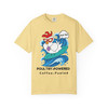 Miss Sally Rides Again Poultry-Powered Surf Tee in soft butter yellow, playful chicken-on-a-board graphic with bright surf energy.