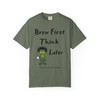 Brew First, Think Later – Bert’s Morning Motto Tee by Coo Coo’s Coffee in moss green, playful caffeine-inspired tee with Bert graphic.