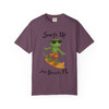 Berry purple short-sleeve tee with Bert the gecko surfing graphic, featuring text “Surfs Up – Jax Beach, FL,” part of Bert’s Surf Club collection by Coo Coo’s Coffee.
