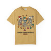 “Mustard yellow tee featuring playful skeletons dancing with coffee beans, design reads ‘Brew Good Vibes – Coo Coo’s Coffee.’”