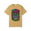 “Mustard yellow tee featuring neon skull with three coffee cups and pumpkin detail, slogan ‘Triple Shot Trickster,’ Caffeine Skull Tee by Coo Coo’s Coffee.”