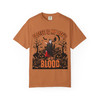 Coffee Is My Life’s Blood’ Halloween graphic t-shirt in pumpkin orange, front view with vampire and pumpkins