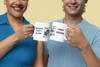 Two friends clinking Bert drummer coffee mugs together, smiling in casual outfits.