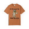 All Wrapped Up Still Brewin Halloween tee - mummy Bert the gecko wrapped in bandages with sunglasses holding coffee mug - front print on burnt orange ring-spun cotton by Coo Coos Coffee Florida Brew Crew