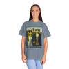 The Americano Gothic coffee tee — two geckos posed as the couple from Grant Wood's American Gothic in front of a white gothic-window farmhouse; Bert in sunglasses holding a pitchfork, Gertie in pearls beside him, with "The Americano Gothic" and a red Florida Brew Crew line beneath — Coo Coo's Coffee Brew Good Vibes garment-dyed Comfort Colors art parody tee.