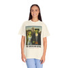 The Americano Gothic coffee tee — two geckos posed as the couple from Grant Wood's American Gothic in front of a white gothic-window farmhouse; Bert in sunglasses holding a pitchfork, Gertie in pearls beside him, with "The Americano Gothic" and a red Florida Brew Crew line beneath — Coo Coo's Coffee Brew Good Vibes garment-dyed Comfort Colors art parody tee.