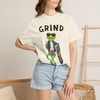 Close-up of the skateboarding gecko Bert grinding a rail with coffee graphic print on the Grind t-shirt, ivory female